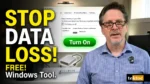 Video thumbnail showing a man in a blue plaid shirt next to large text reading 'STOP DATA LOSS! FREE! Windows Tool.' and a Windows File History window with a green 'Turn On' button.